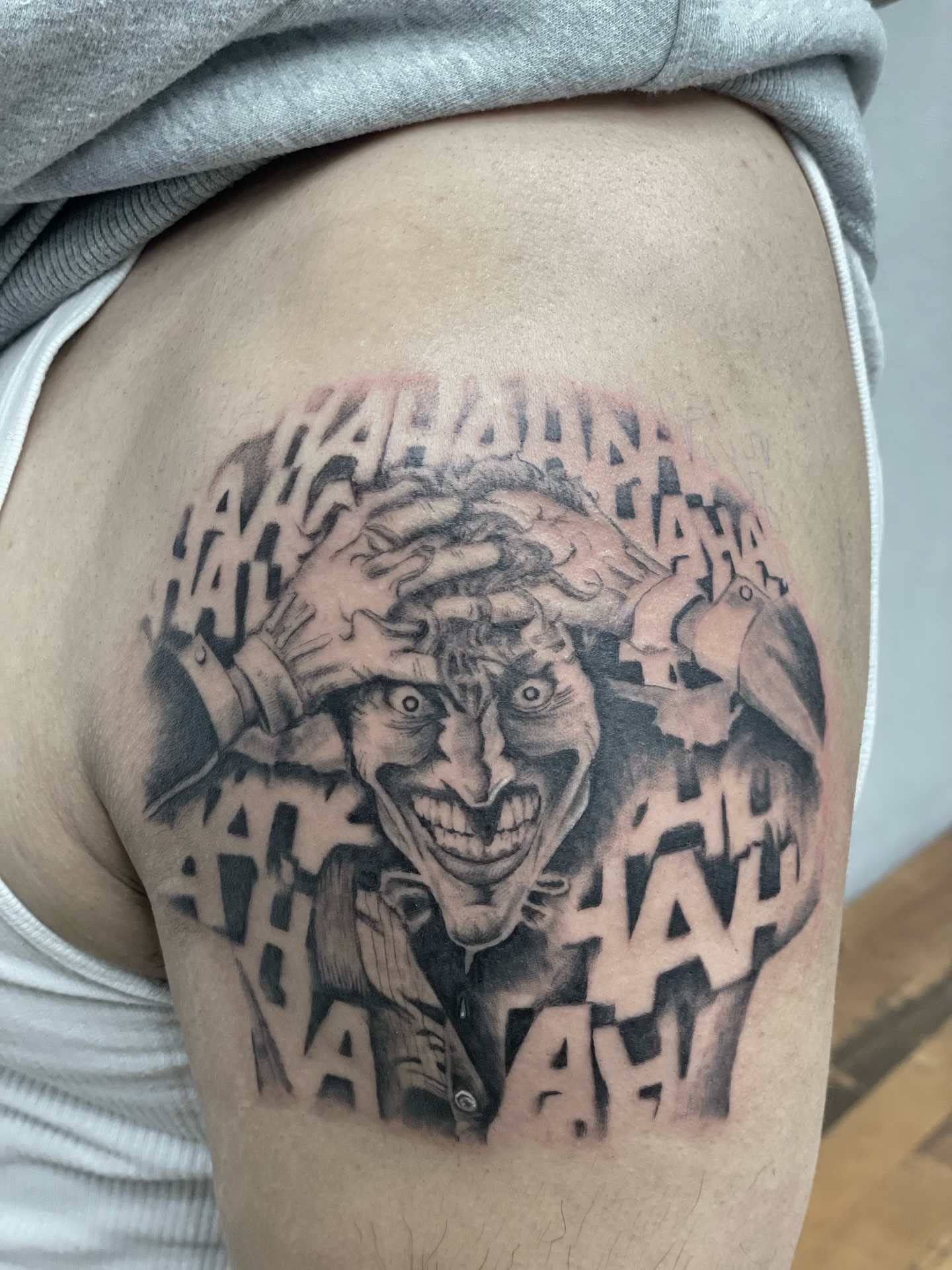 Joker black and grey tattoo on the thigh by Koolz