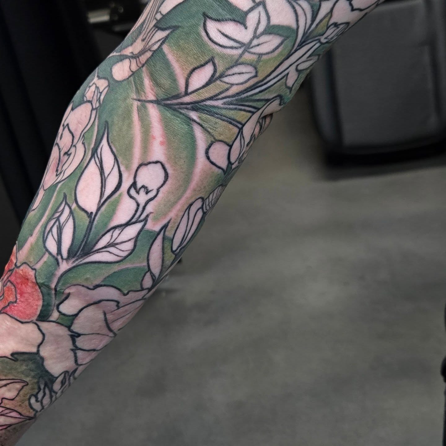 Floral bouquet new school tattoo on the forearm by Jamie Clinton
