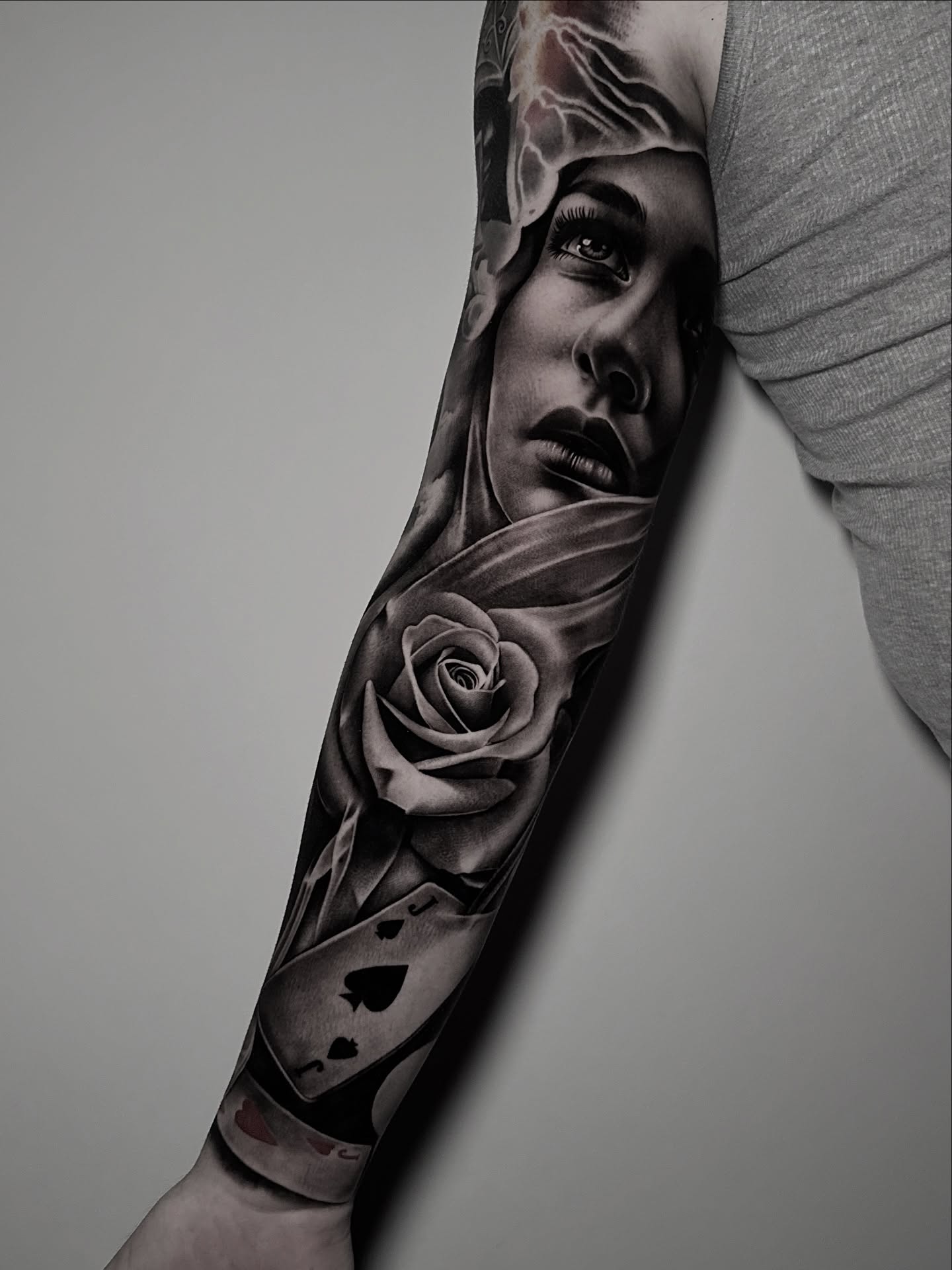 Portrait with rose realism tattoo on the forearm by Miguel Saucedo