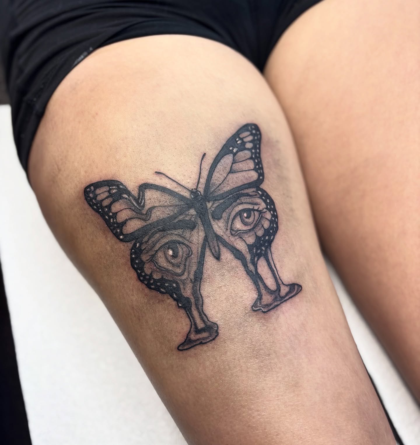 Butterfly and eyes realism tattoo on the thigh by Nashville Tattoo Artist