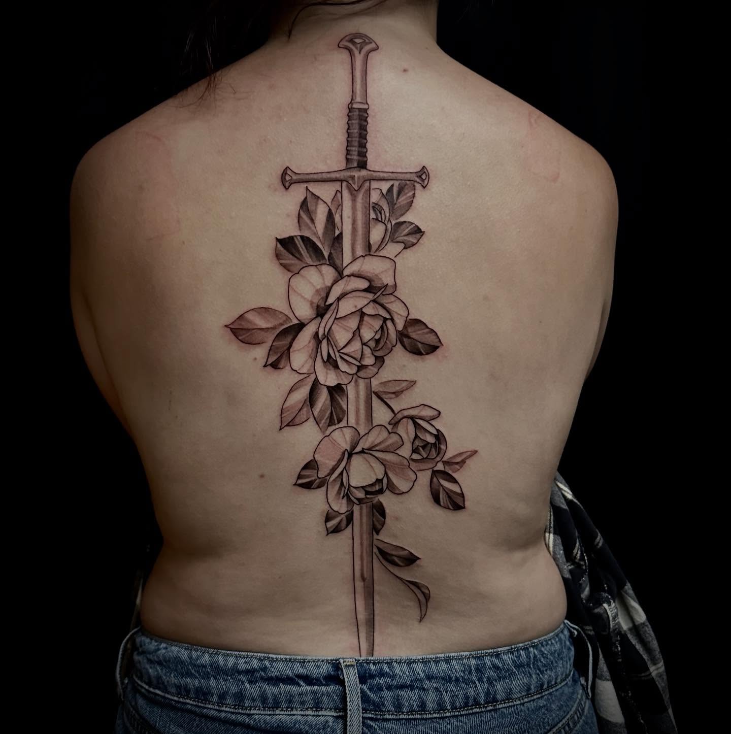 Sword and roses black and grey tattoo on the back by Sebastian Livingston
