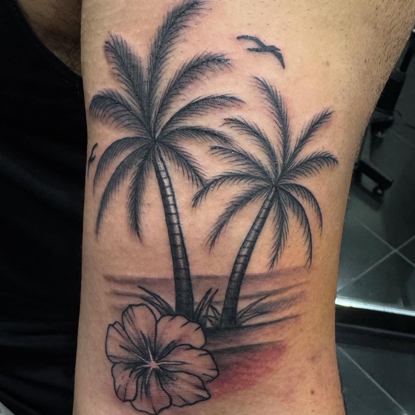 Palm trees and hibiscus realism tattoo on the forearm by Brian Herrera