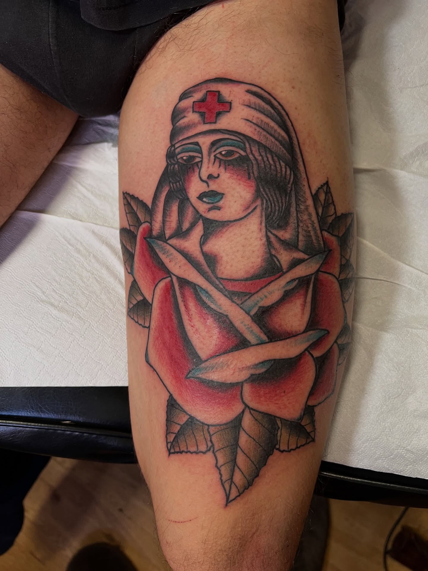 Nurse with cross American traditional tattoo on the thigh by Alessandro Pennella