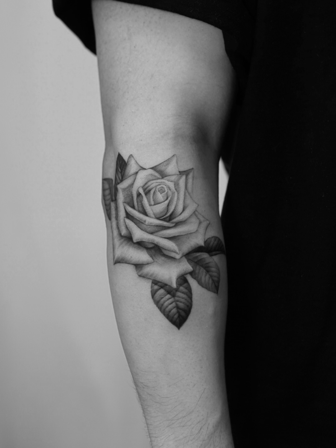 Rose realism tattoo on the forearm by Ray Quinday