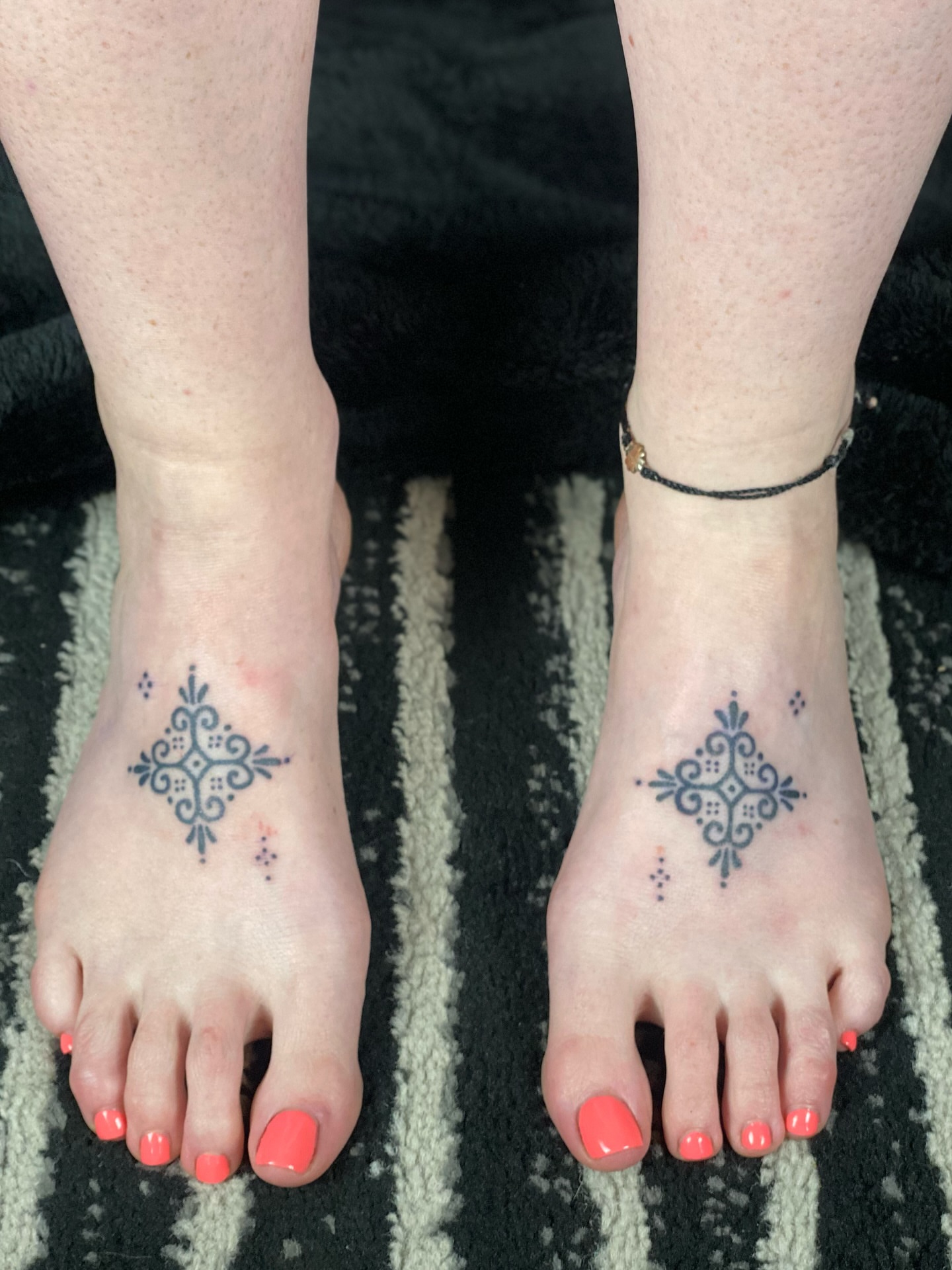 Cross geometric tattoo on the foot by Handpoked Tattoos