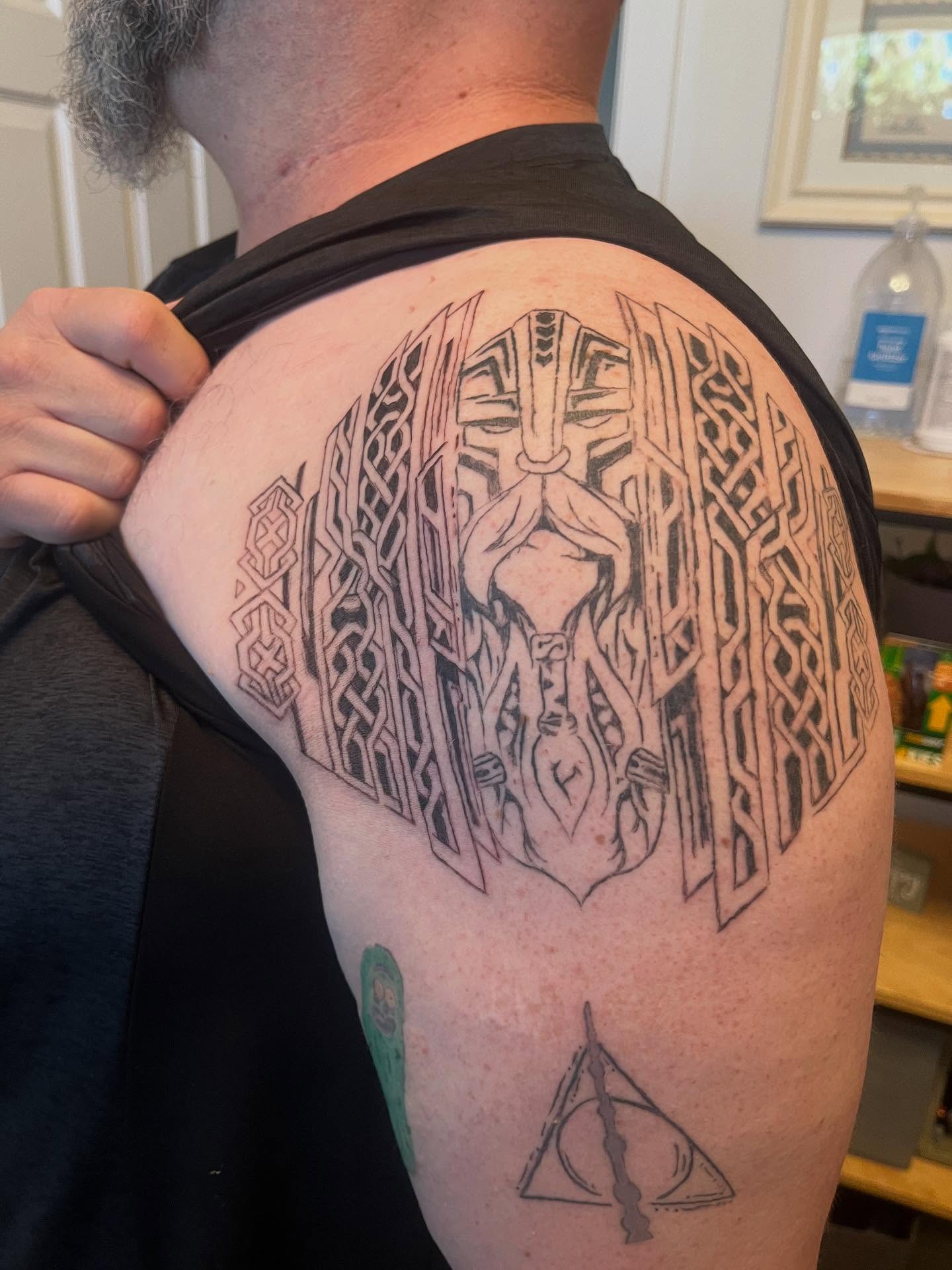 Deity figure geometric tattoo on the shoulder by Val Maughan