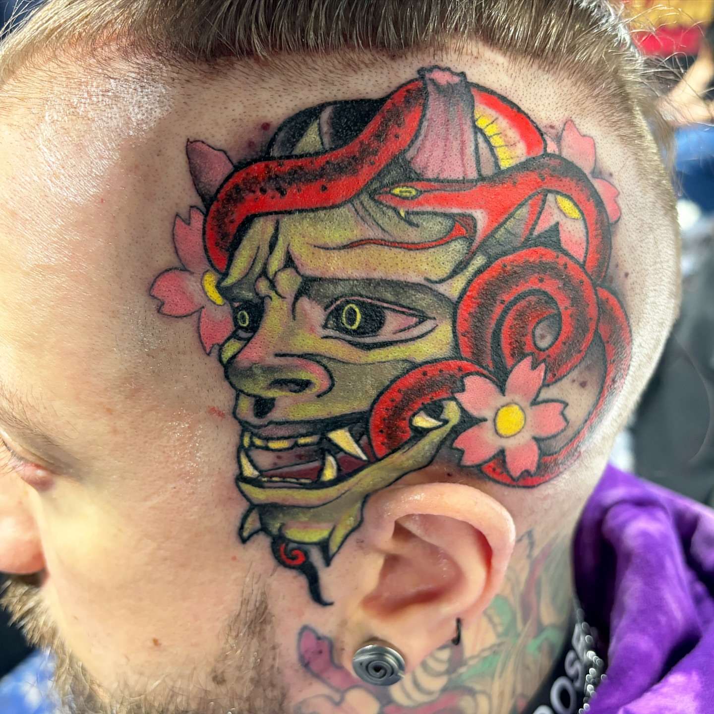 Demon mask American traditional tattoo on the neck by Matt Stolzenburg