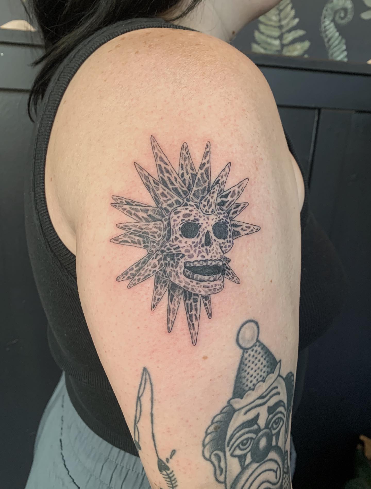 Sun-like skull black and grey tattoo on the shoulder by Jess, Midvale, Utah