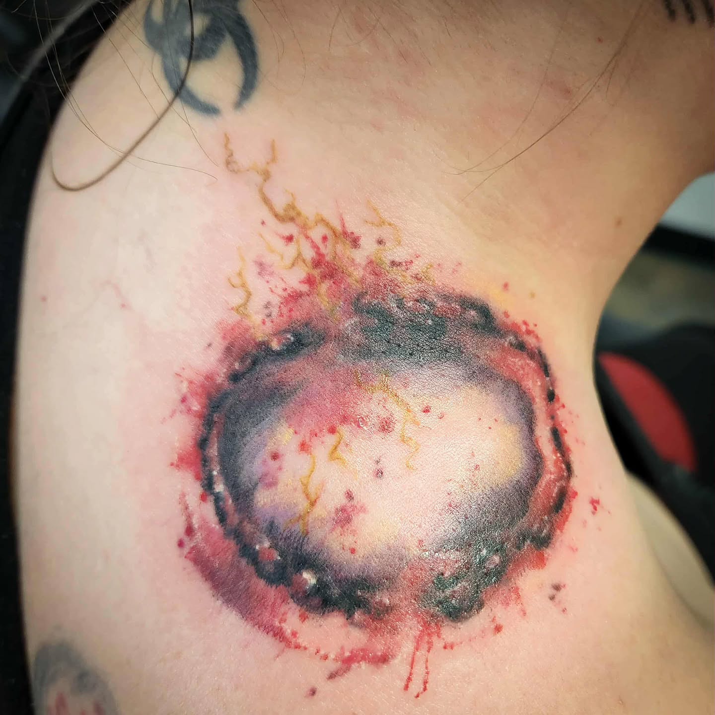Cosmic explosion watercolor tattoo on the shoulder by Samantha Von Zombia, Saint Paul, Minnesota