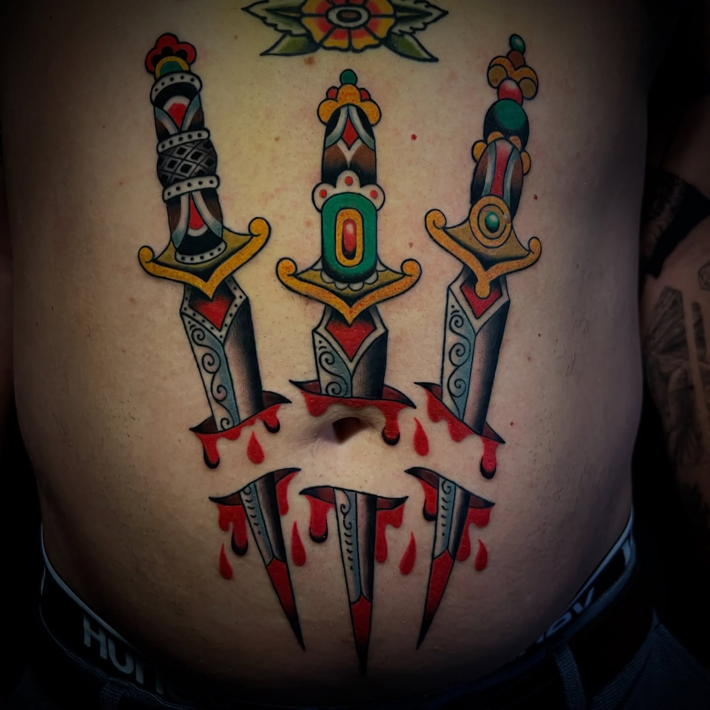 Knives and blood American traditional tattoo on the torso by Michael Munter, Philadelphia, Pennsylvania