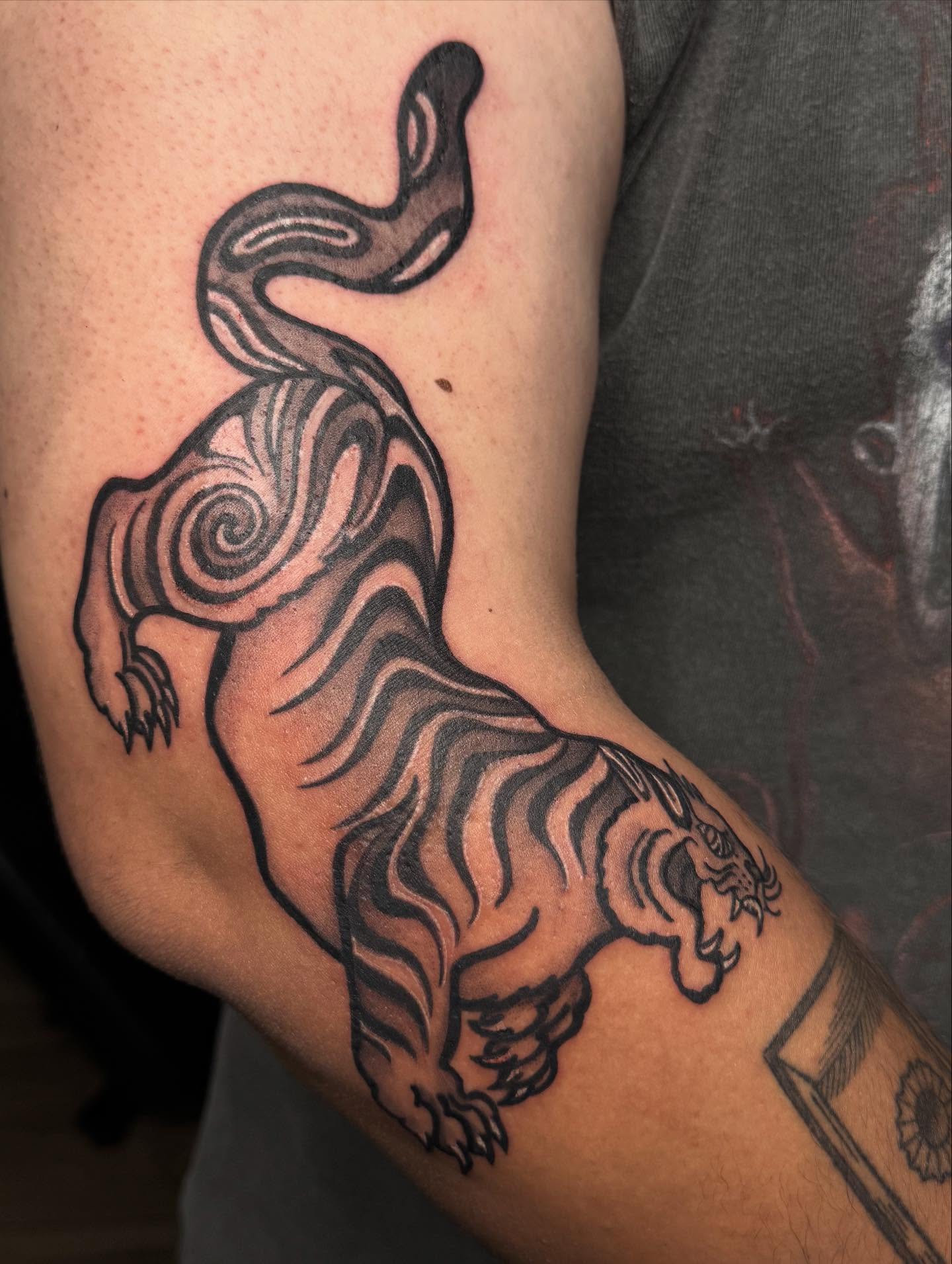 Tiger black and grey tattoo on the forearm by Mickey