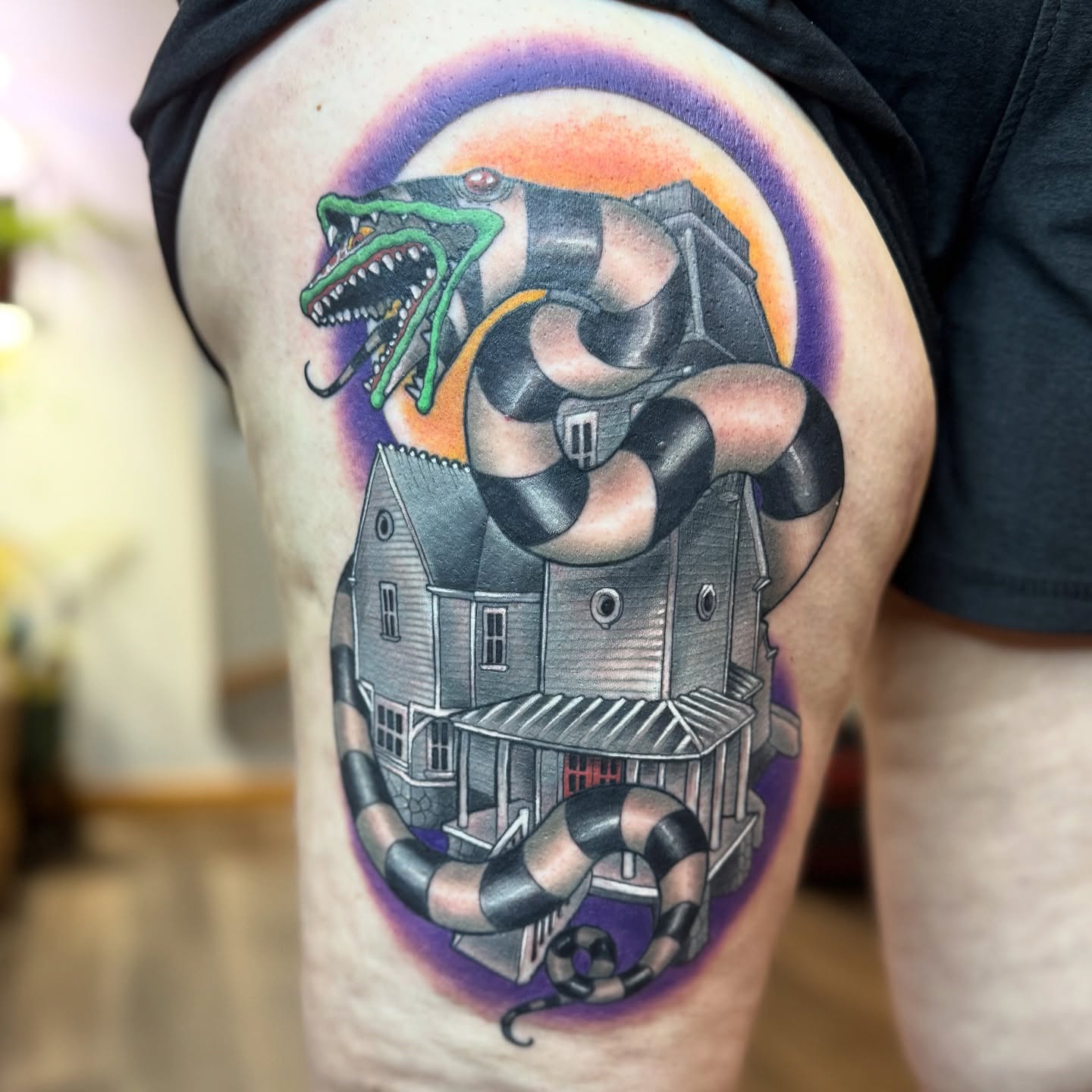 Haunted house with snake American traditional tattoo on the thigh by Erin Bratzler
