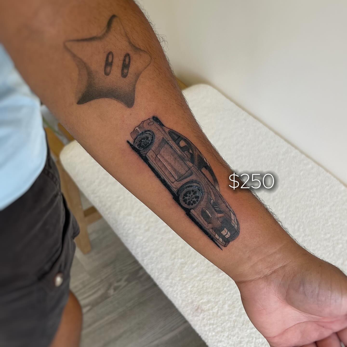 Car black and grey tattoo on the forearm by David