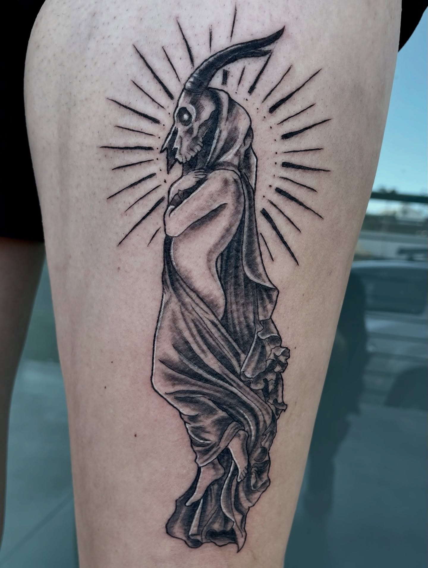 Reaper black and grey tattoo on the thigh by Jessica Burridge