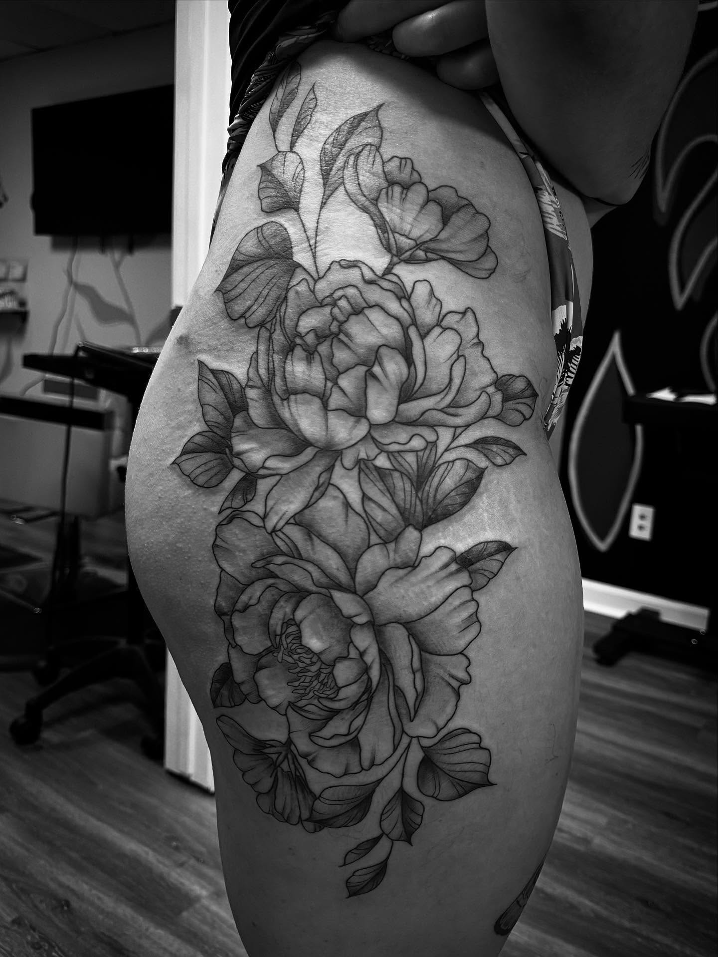 Peony flowers black and grey tattoo on the thigh by Bethany Foeller