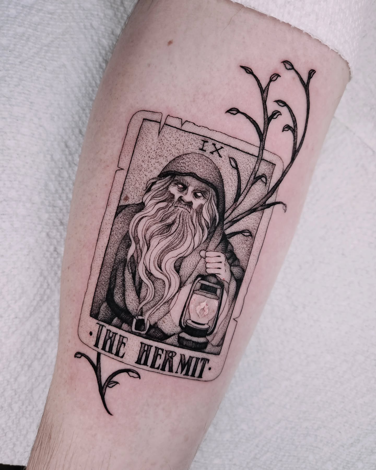 The hermit tarot card black and grey tattoo on the forearm by Sabrina Wagner