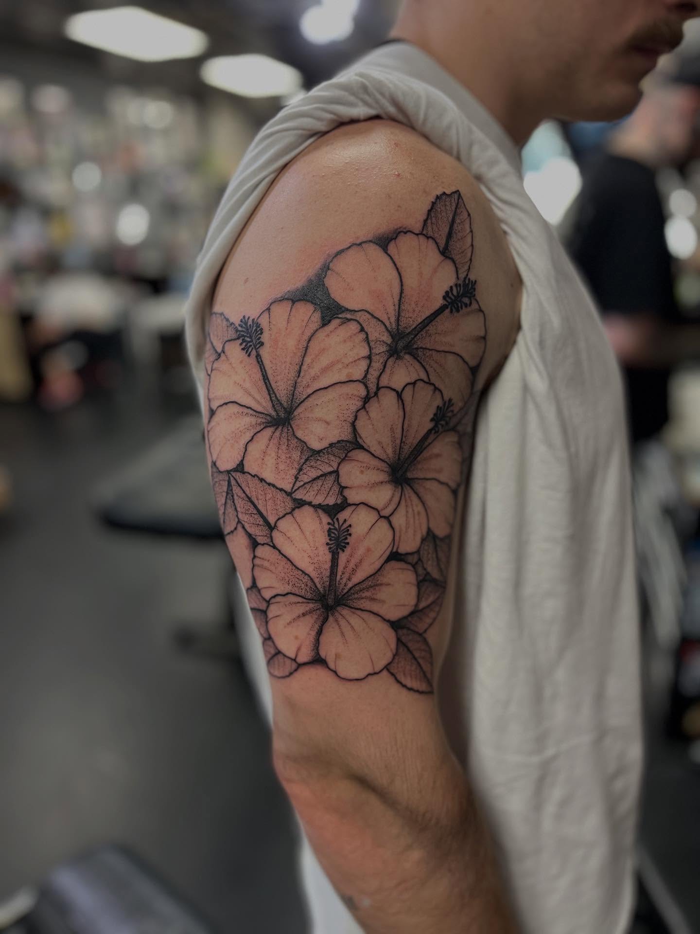 Hibiscus flowers black and grey tattoo on the upper arm by CRAIG B⛓️ Cincinnati Tattoo Artist