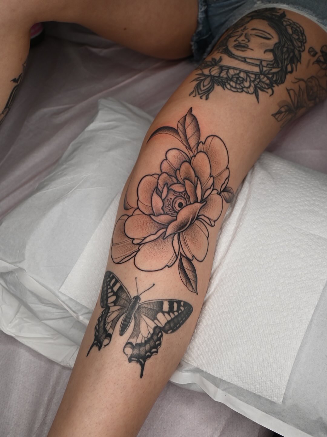 Flower and butterfly black and grey tattoo on the forearm by Simba Nguyen