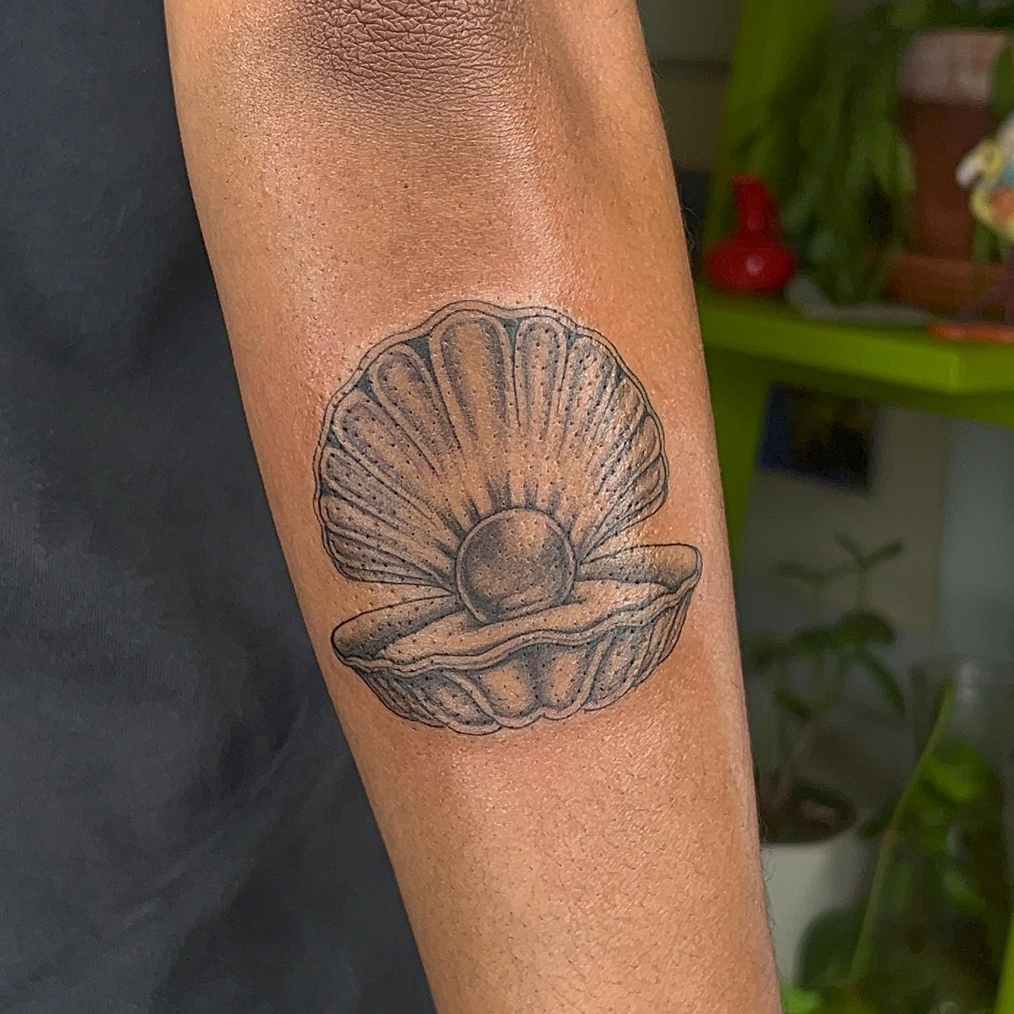 Scallop shell black and grey tattoo on the forearm by ༻𝐓𝐡𝐞 𝐒𝐤𝐢𝐧 𝐆𝐚𝐫𝐝𝐞𝐧༺