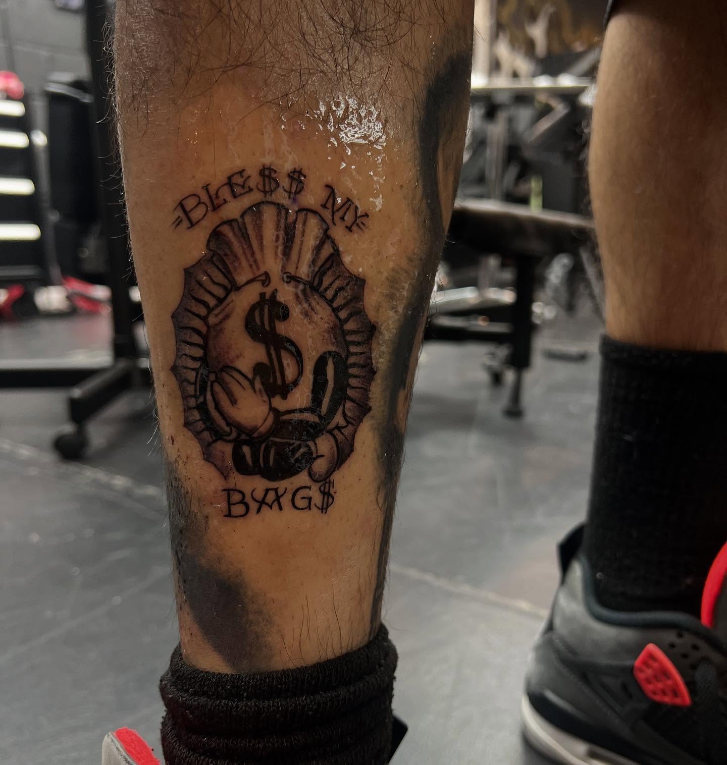 Dollar sign with hands black and grey tattoo on the forearm by @_frankyvee