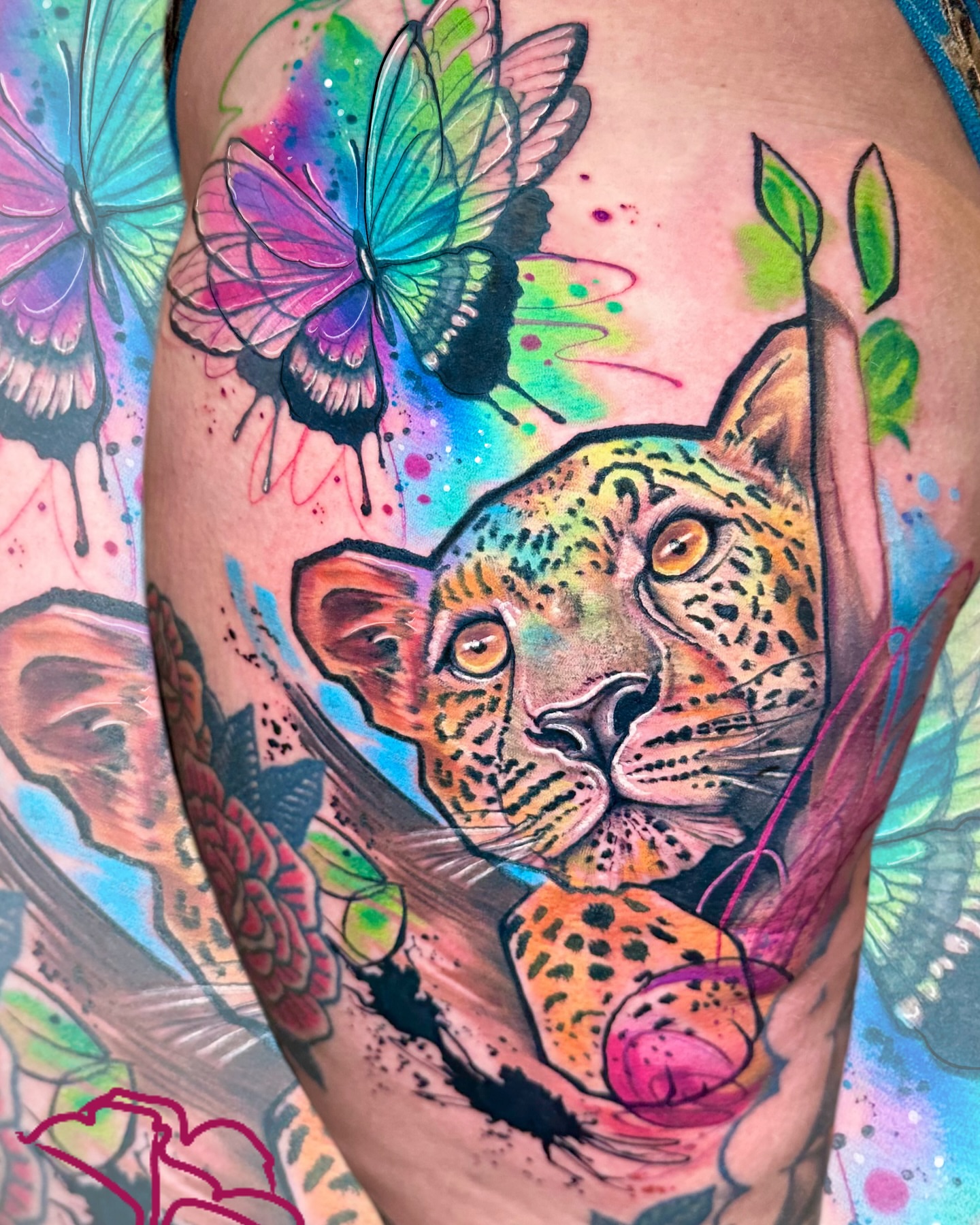 Jaguar and butterflies watercolor tattoo on the thigh by Alena Petunia