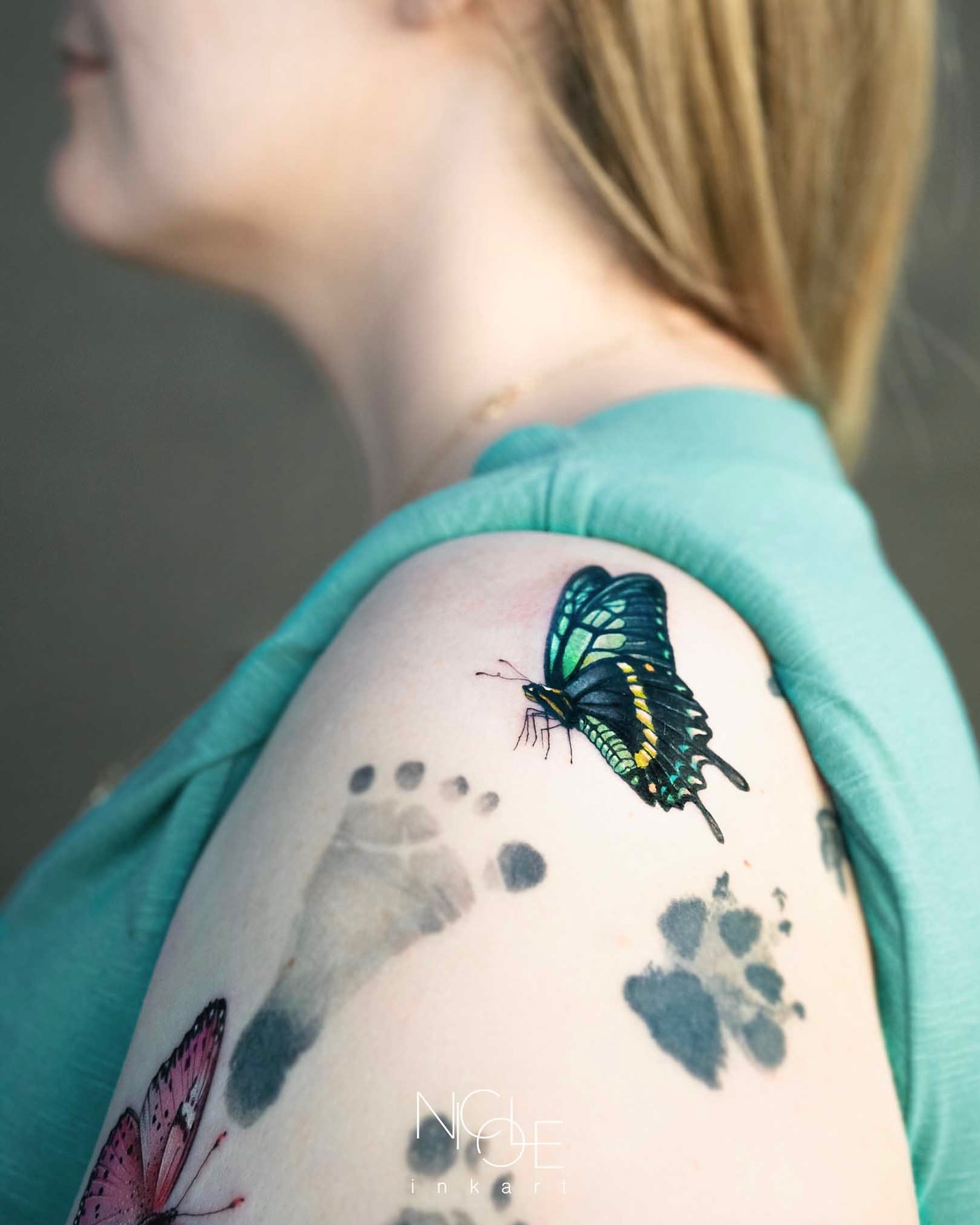 Butterfly and footprints realism tattoo on the shoulder by 𝐍𝐈𝐂𝐎𝐋𝐄 𝐋