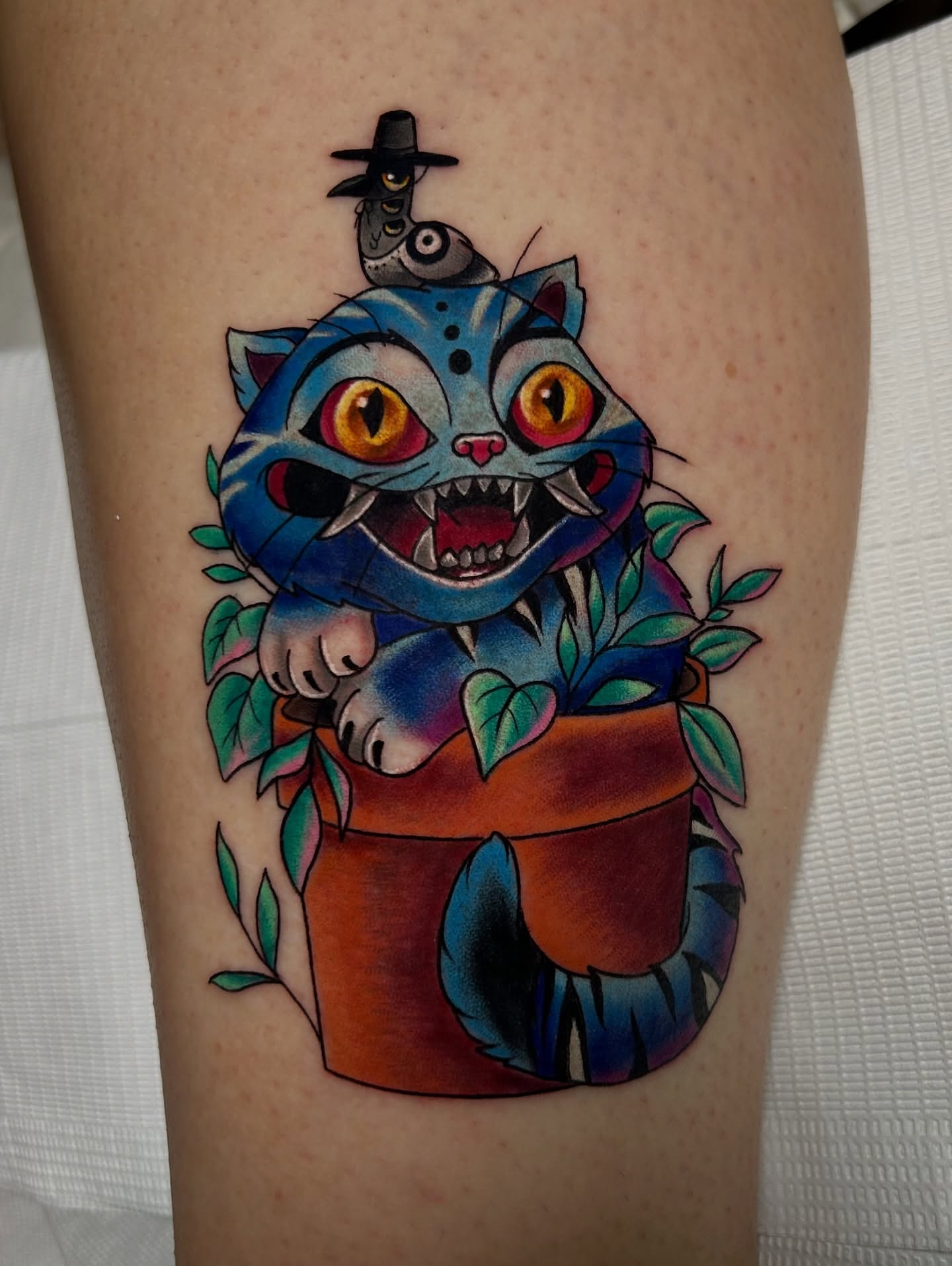 Cat in pot American traditional tattoo on the thigh by Tattoos By Lola Cavotta, Willoughby, Ohio