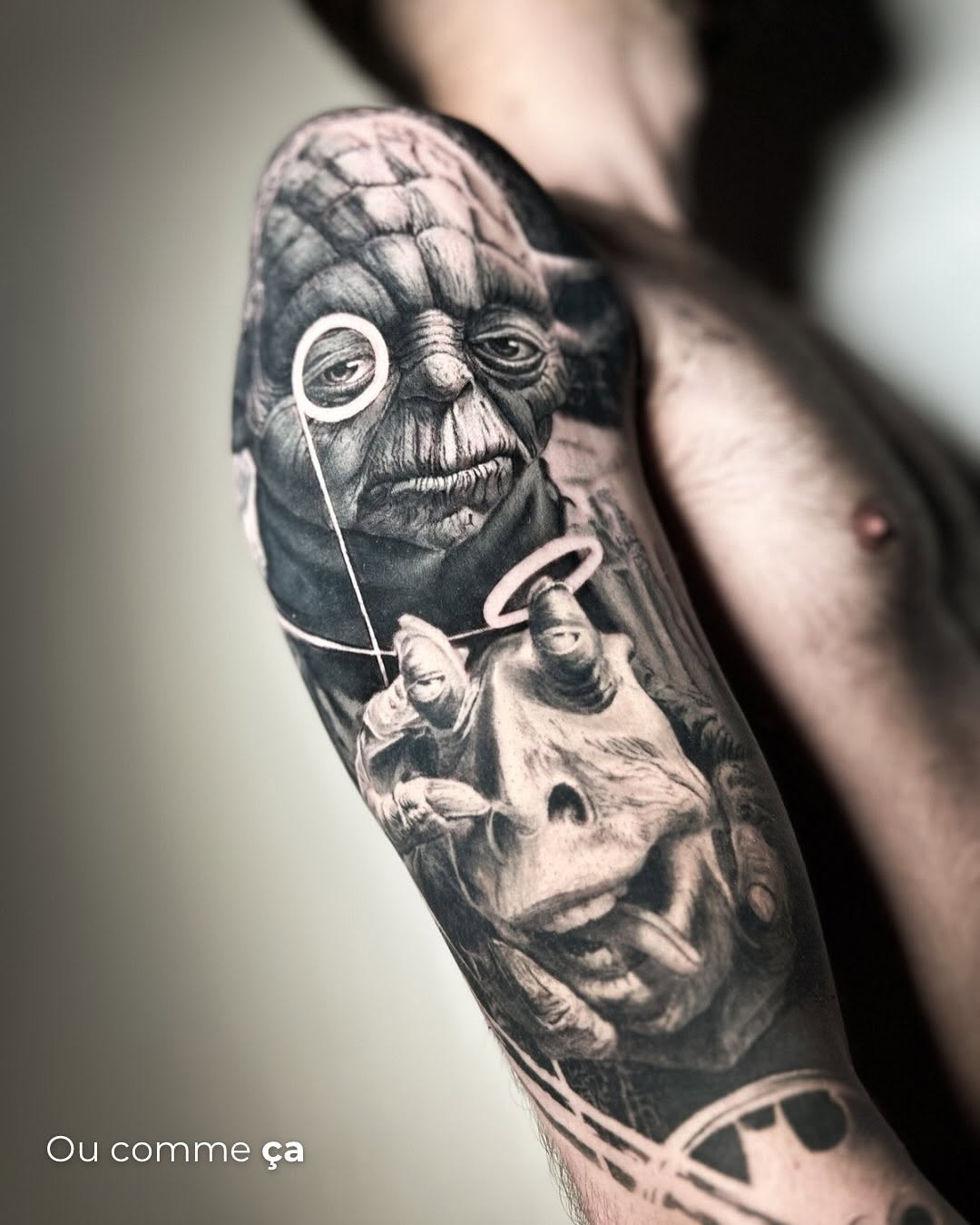 Yoda and another creature surrealism tattoo on the forearm by Eltche Art Tattoo