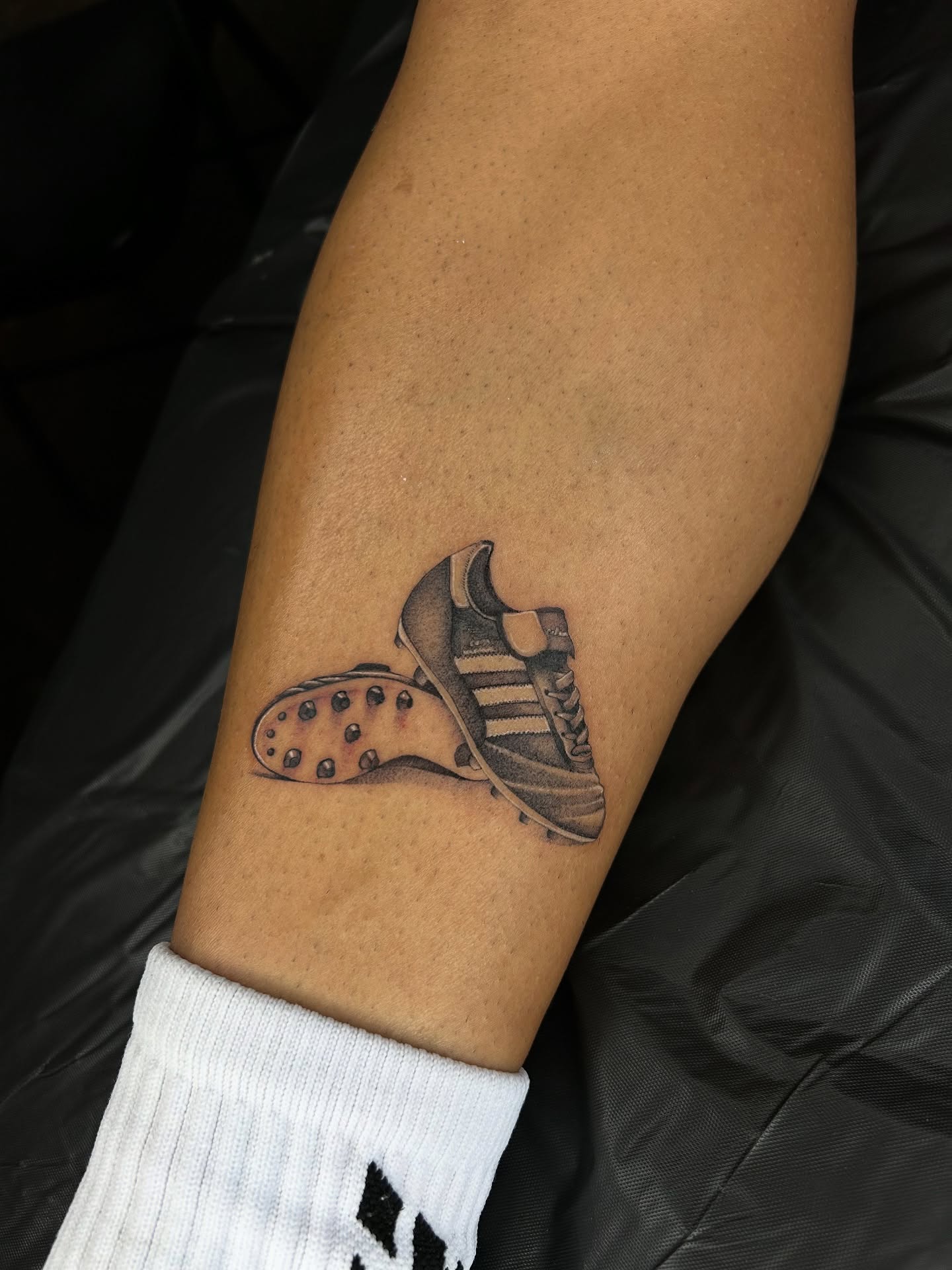 Football boot black and grey tattoo on the forearm by ✭ Elisa ✭