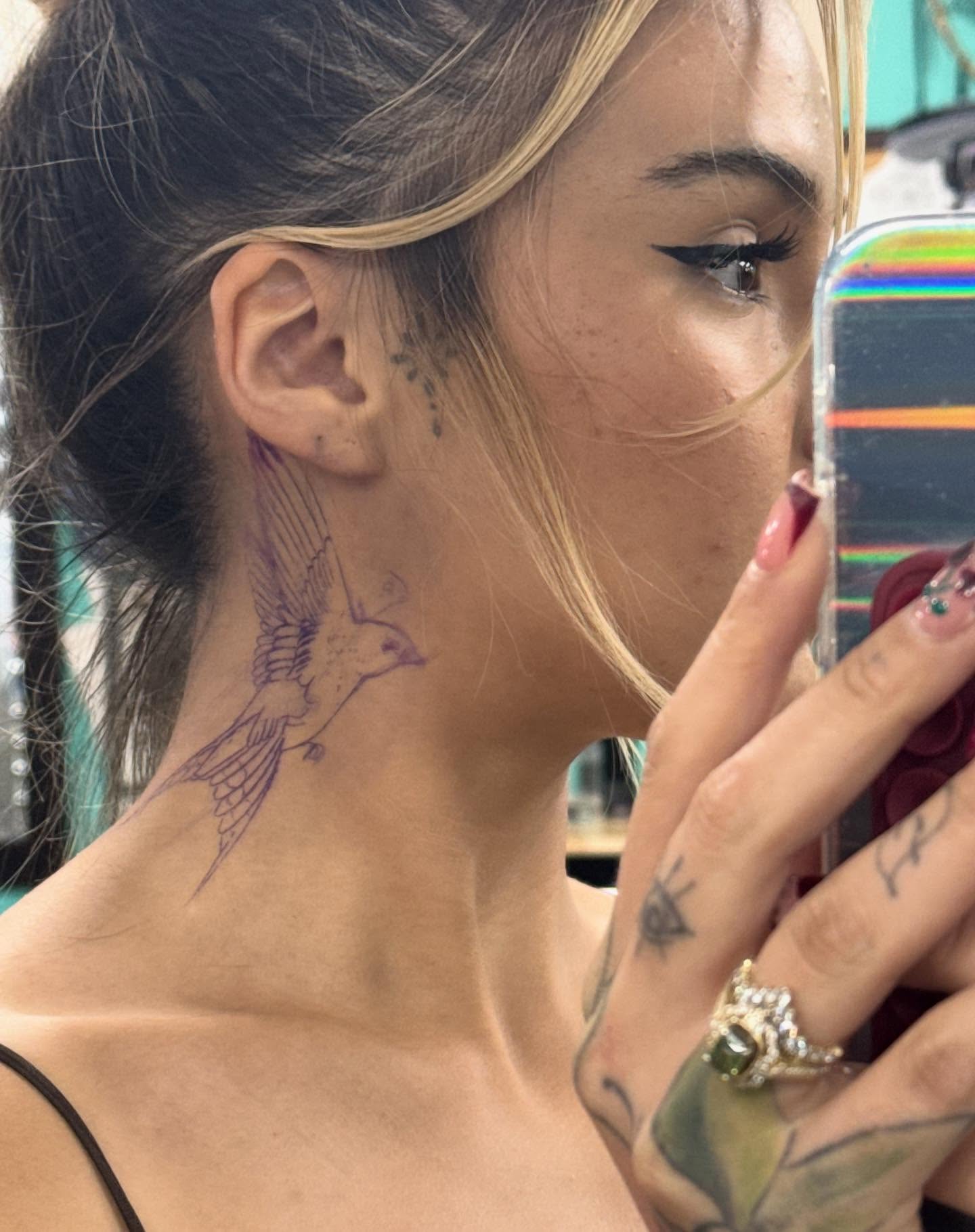 Bird fine line tattoo on the neck by Nathalie Briseno