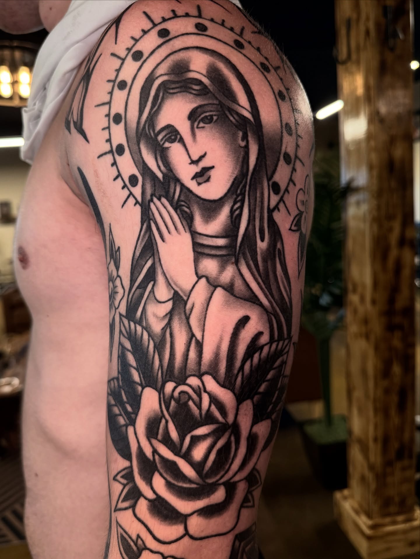 Religious figure American traditional tattoo on the upper arm by Cory Allen