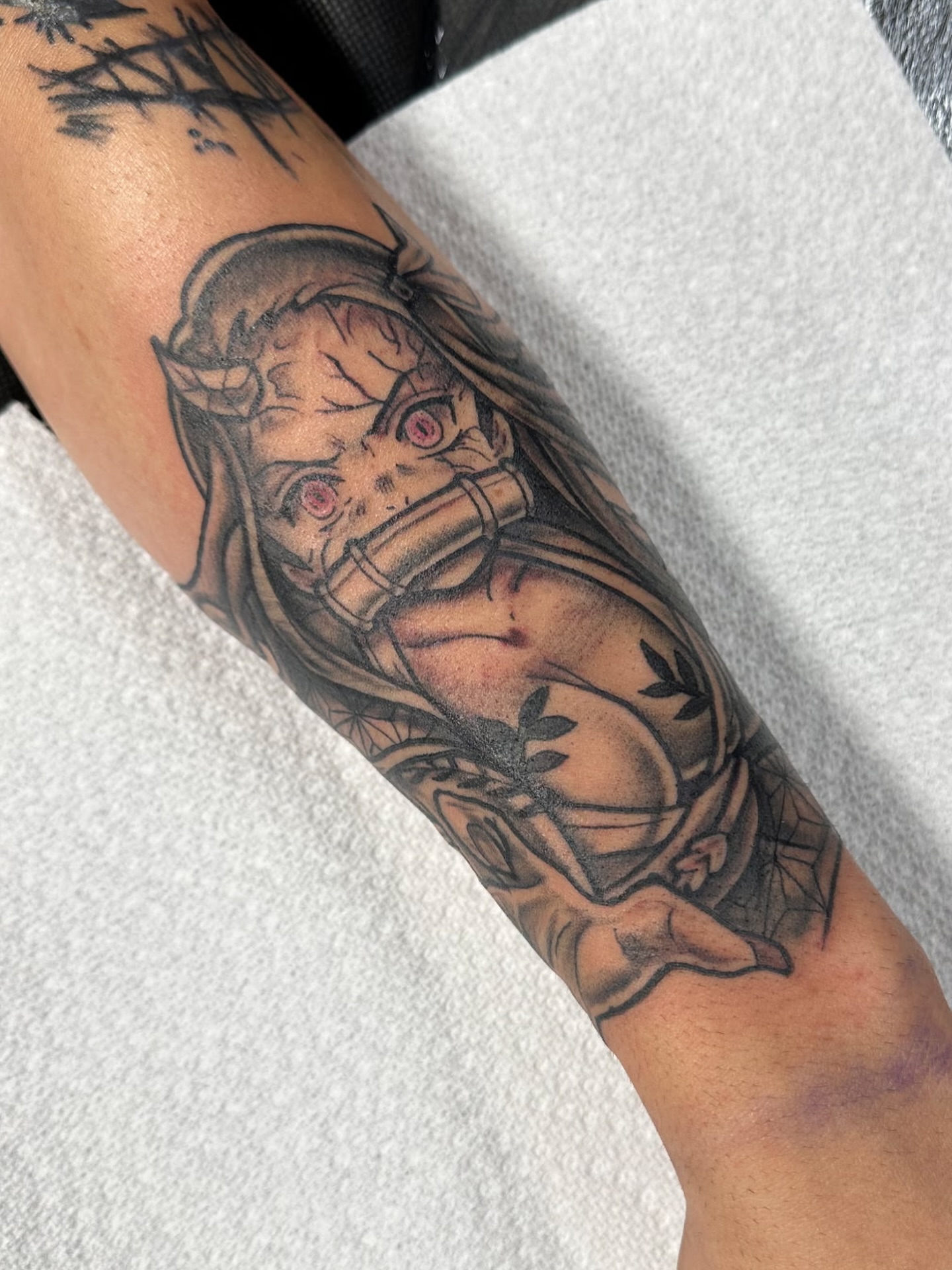 Anime character anime tattoo on the forearm by Emily K Lingg