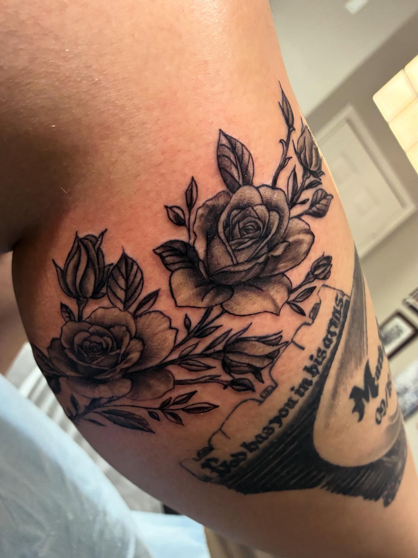 Roses black and grey tattoo on the upper arm by Nessa, Las Vegas, Nevada
