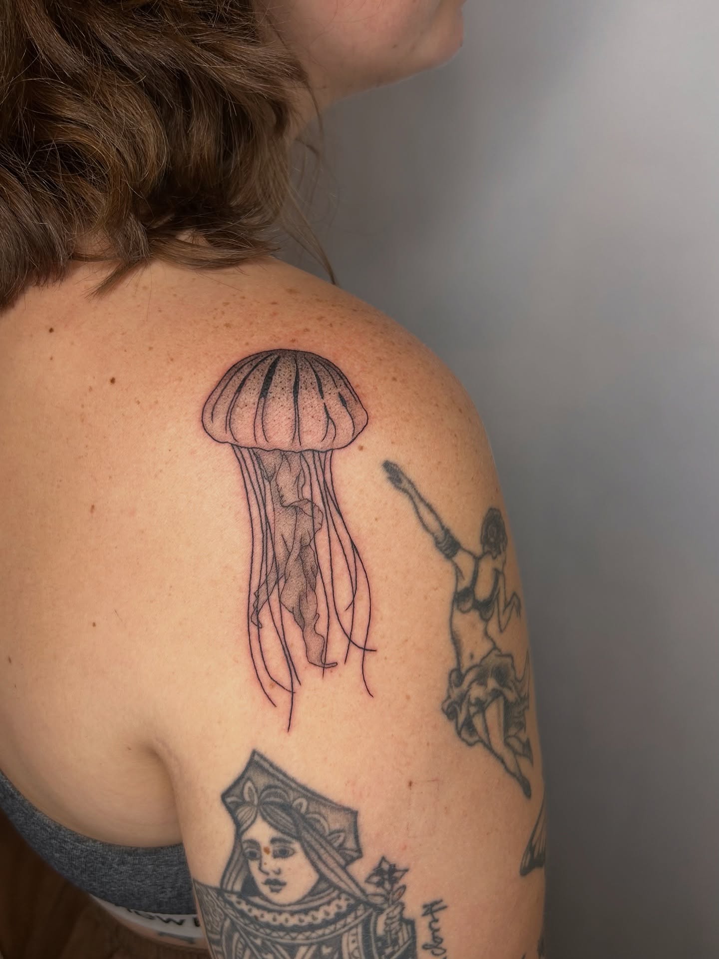 Jellyfish black and grey tattoo on the shoulder by beth