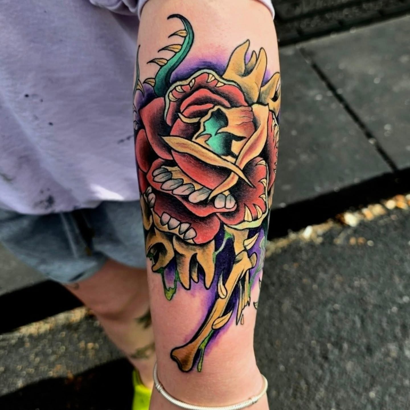 Rose and skull American traditional tattoo on the forearm by Michael Latendresse