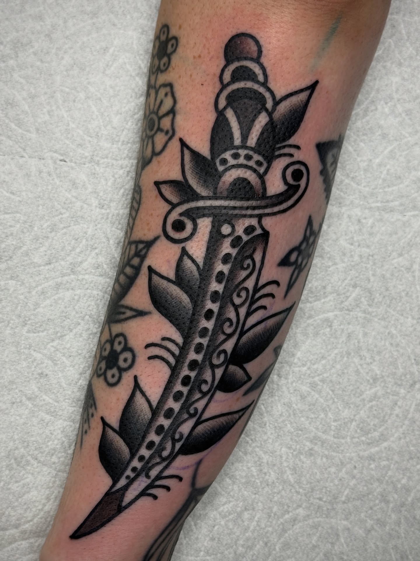 Sword American traditional tattoo on the forearm by Jordan Allen