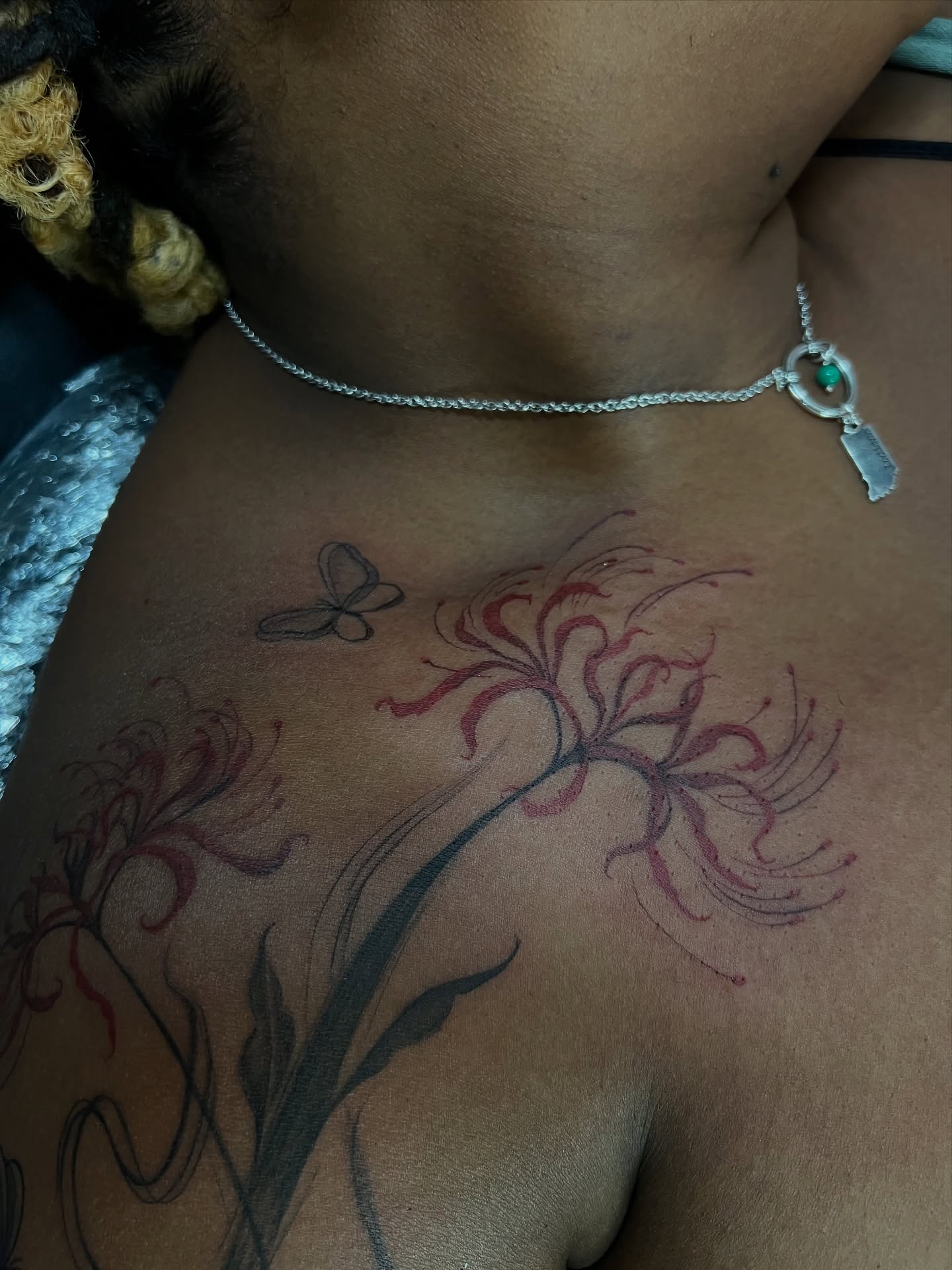 Lilies and butterfly black and grey tattoo on the chest by tatman cris 🥀 dfw tattoo artist