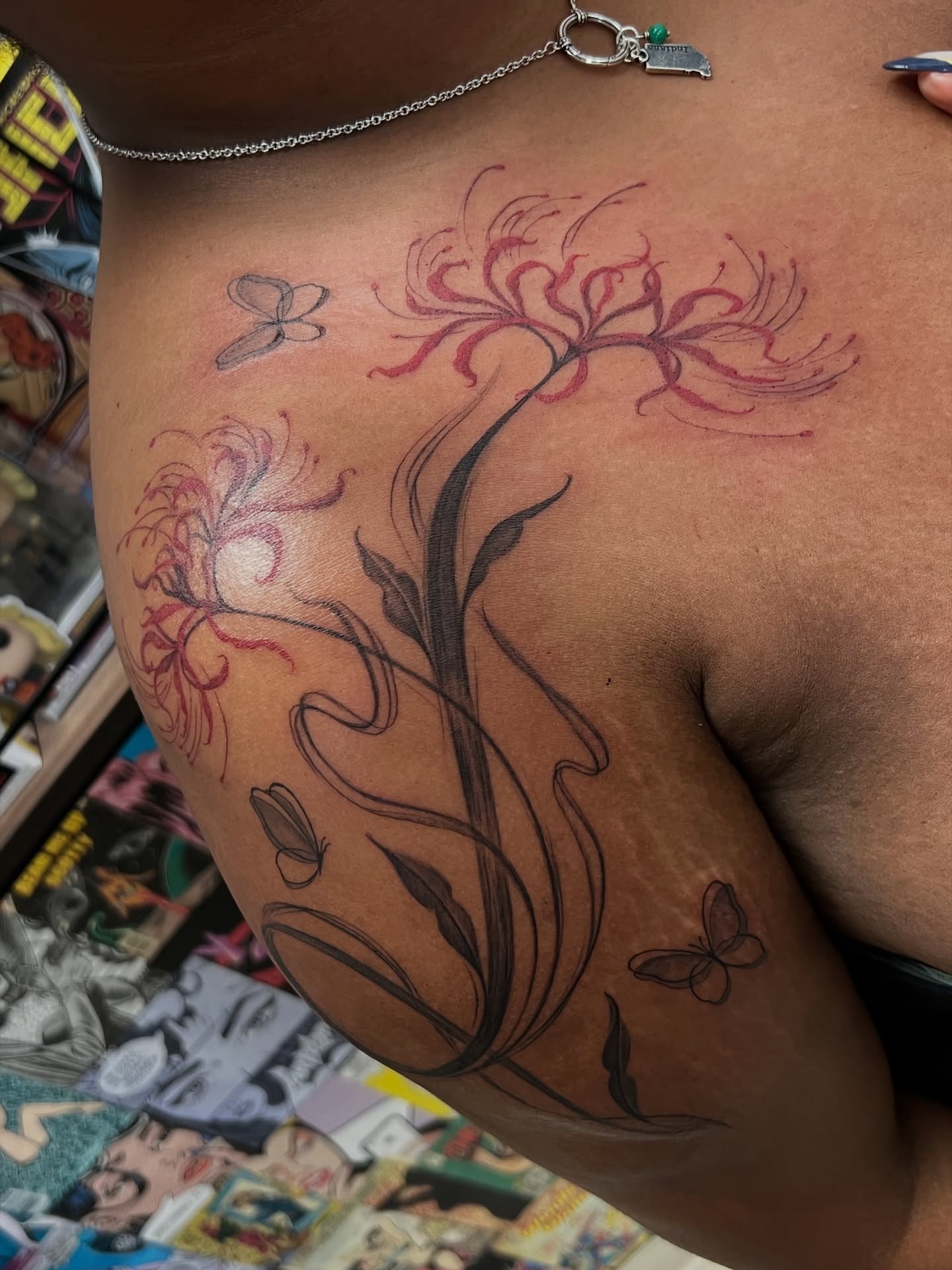 Lilies and butterflies black and grey tattoo on the shoulder by tatman cris 🥀 dfw tattoo artist