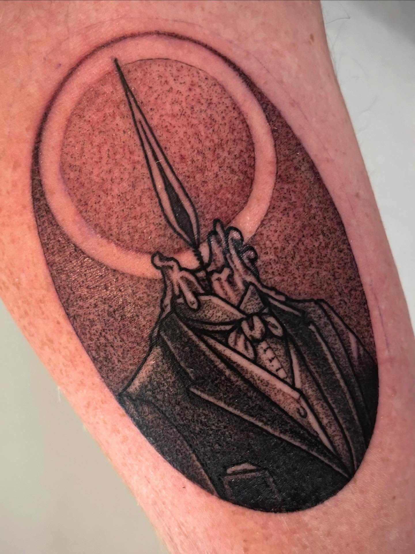 Suit and sword black and grey tattoo on the forearm by Tara, Exeter, Pennsylvania