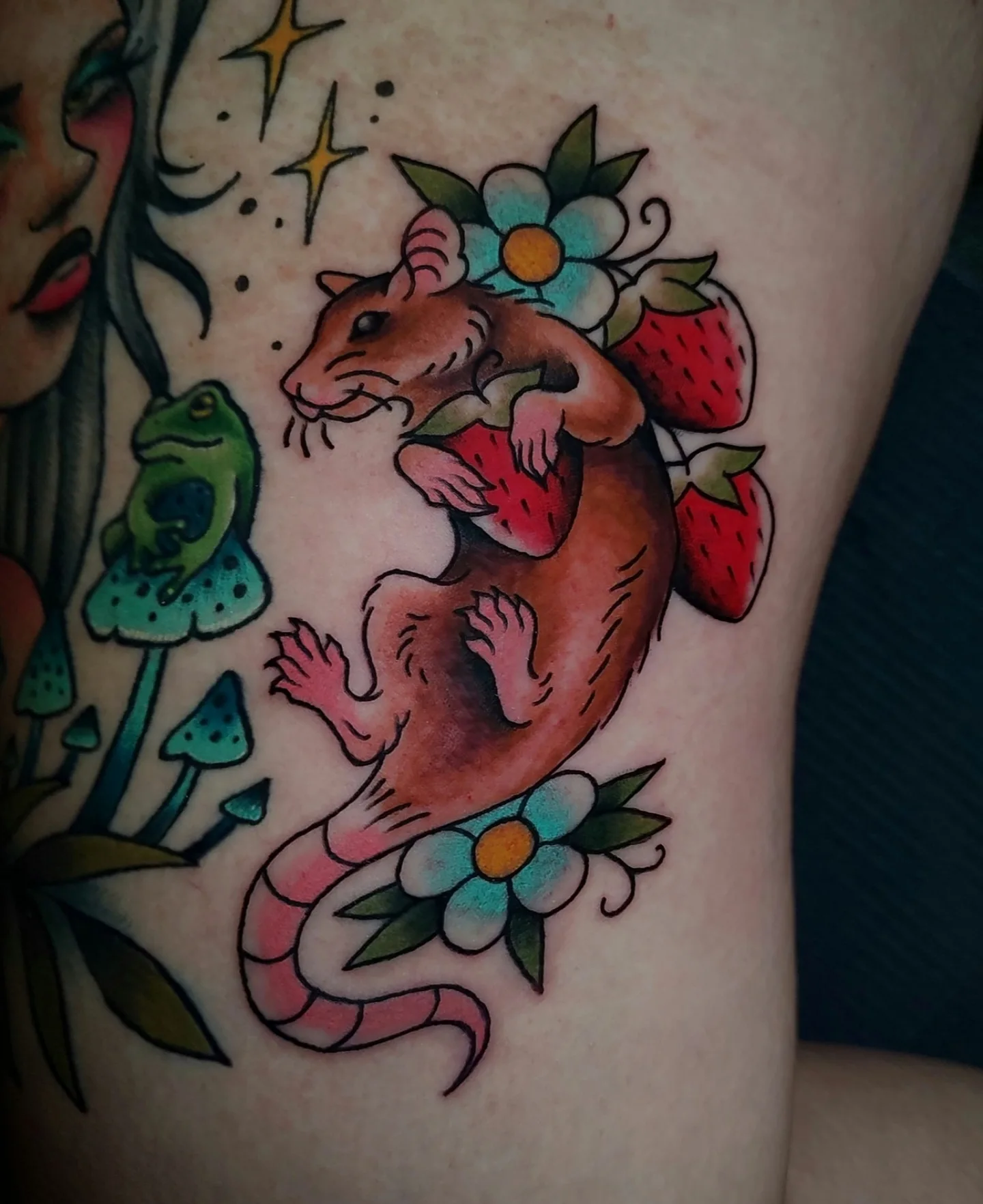 Mouse and strawberries American traditional tattoo on the thigh by Hope Higgins