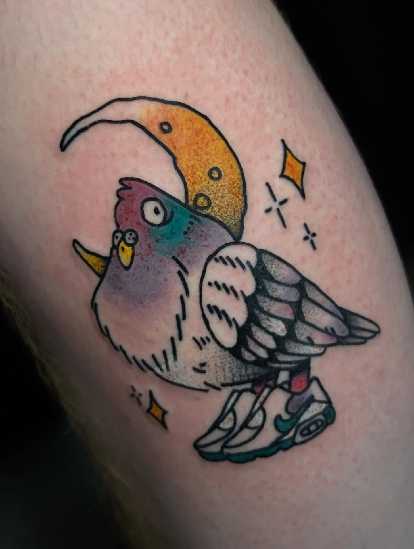 Parrot wearing sneakers American traditional tattoo on the forearm by Tim Wilson