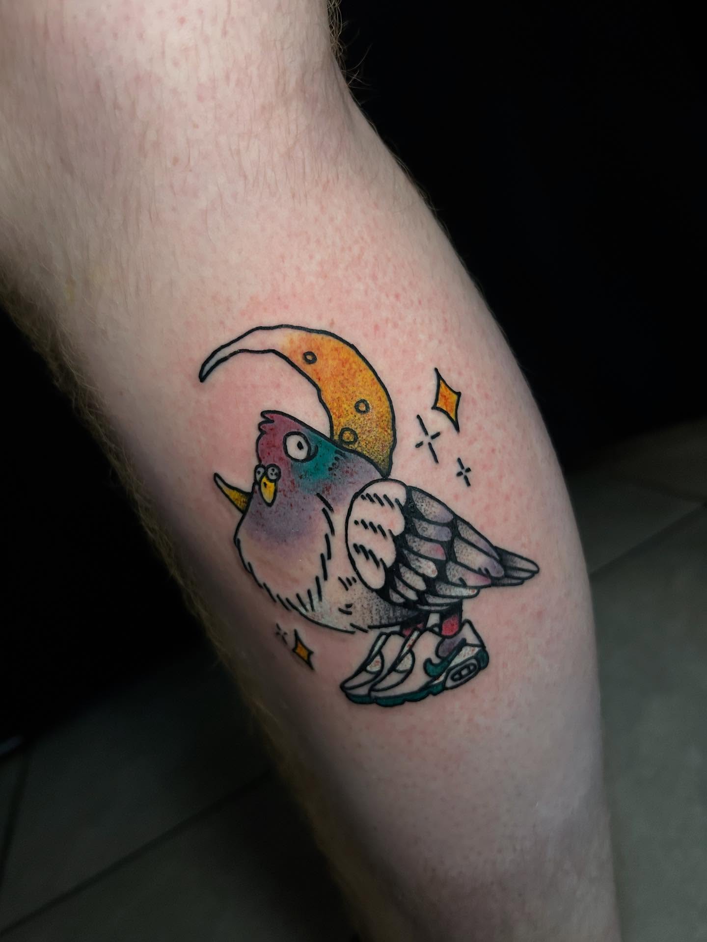 Bird wearing sneakers new school tattoo on the forearm by Tim Wilson