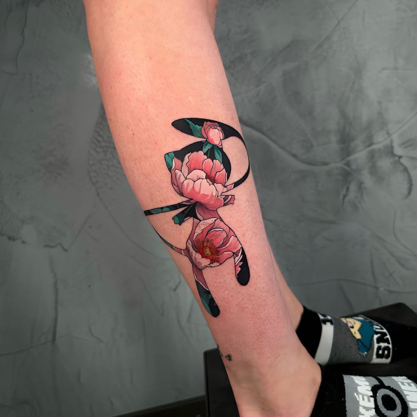Peony flowers new school tattoo on the forearm by Ethan Lund