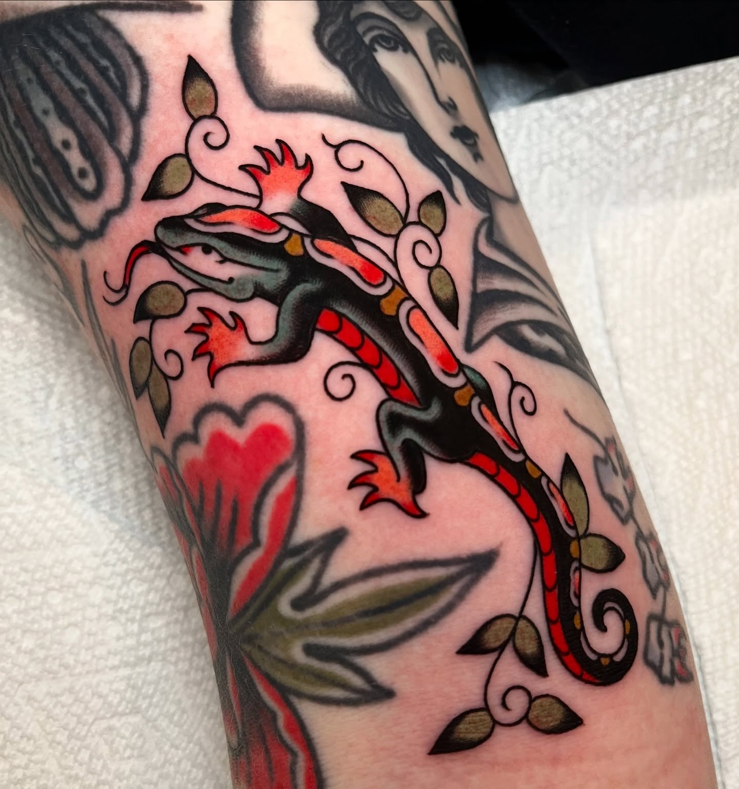 Gecko and floral American traditional tattoo on the forearm by kate