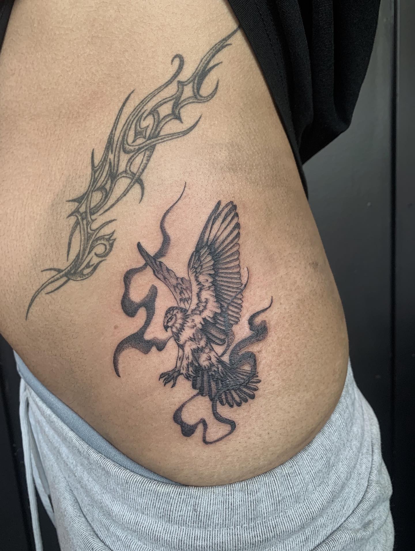 Bird and dragon tribal tattoo on the ribs by Jess, Midvale, Utah