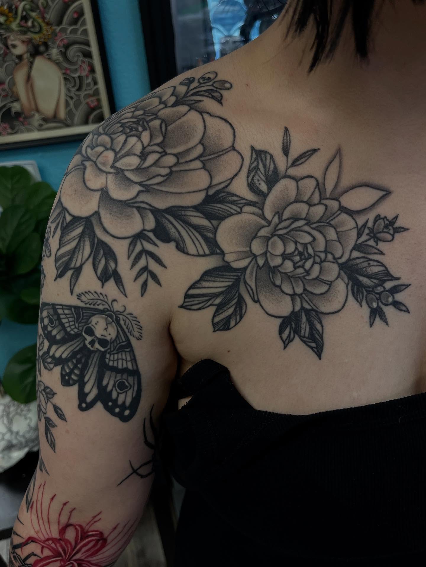 Flowers and moth realism tattoo on the shoulder by Sacramento Tattoos (Ilona)