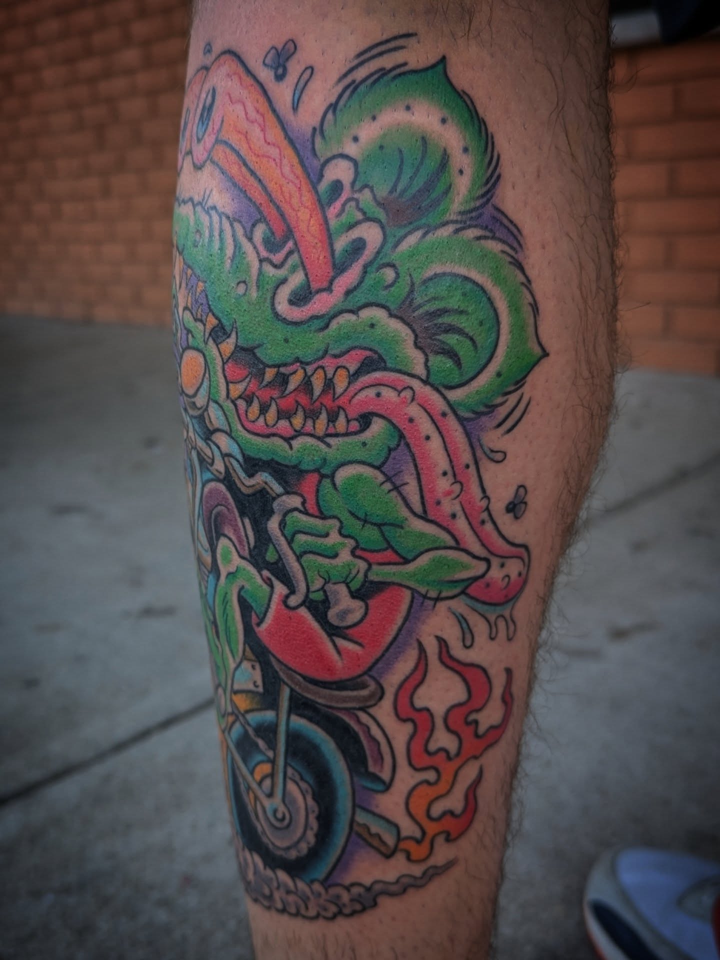 Monster on motorcycle new school tattoo on the leg by Ryan Slegel
