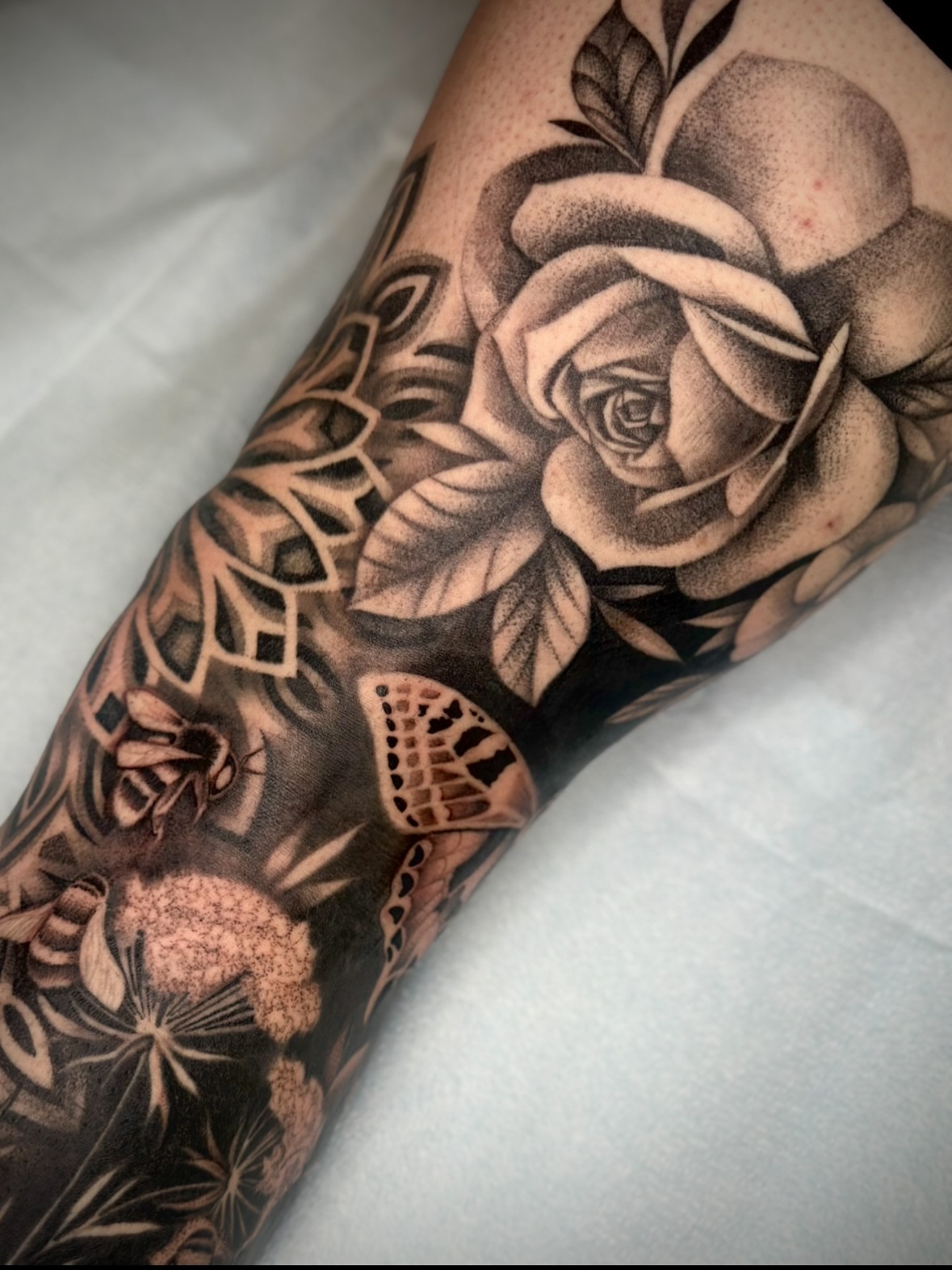 Rose and floral elements realism tattoo on the forearm by Feliz Manzanedo, Prescott, Arizona