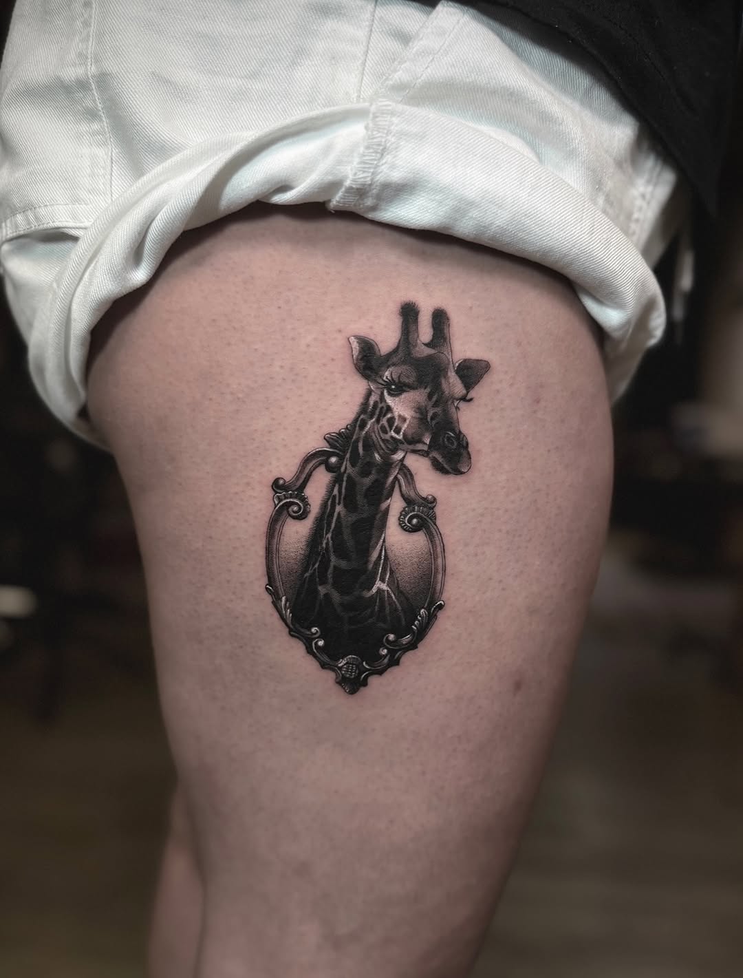 Giraffe head in ornate frame realism tattoo on the thigh by ๐
๐๐๐๐ณ๐ฎ๐ฆ๐ข ๐๐๐ญ๐ญ๐จ๐จs
