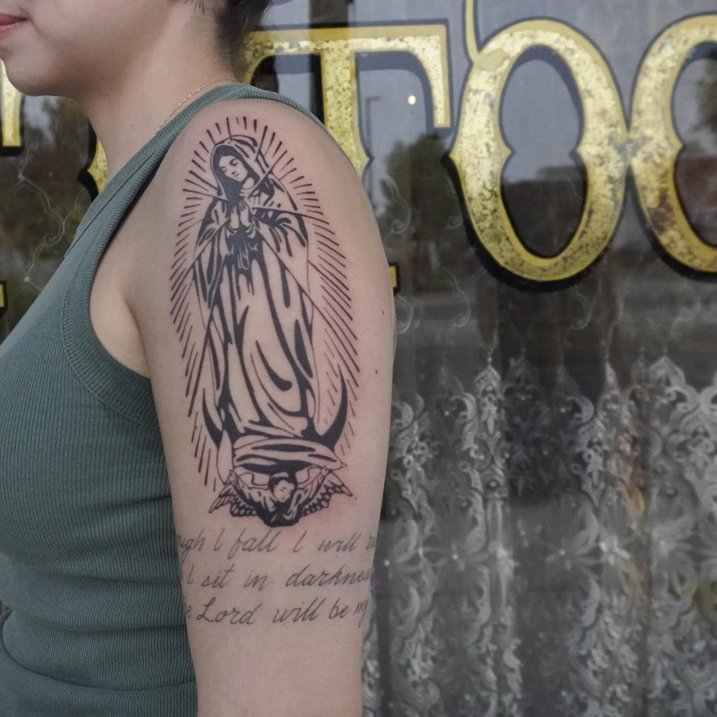 Virgin mary black and grey tattoo on the upper arm by San Diego tattoo artist